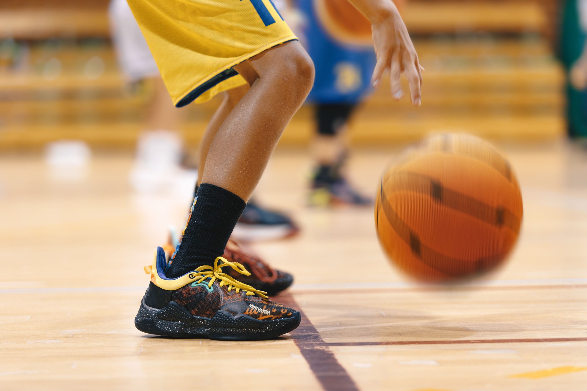 Young Boy's Intense Basketball Training on the Court of Champions. School Kids Showcasing Basketball Skills on Training Court. Youth Basketball Player Standing on Court Line and Bouncing Ball